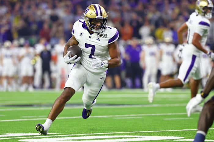 Jan 8, 2024; Houston, TX, USA; Washington Huskies running back Dillon Johnson (7) runs with the ball against the Michigan Wolverines during the second quarter in the 2024 College Football Playoff national championship game at NRG Stadium.